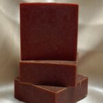 Three bars of Bloom soap stacked without wrappers.