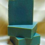 3 bars of Brawn Soap stacked up on a champagne colored background.
