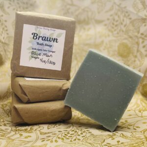 Four bars of Brawn scented soap, one tilted on its edge and the other three wrapped and labeled.