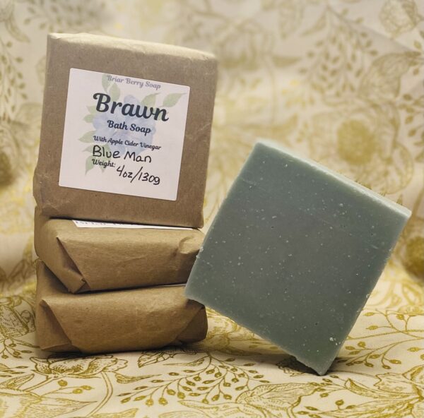 Four bars of Brawn scented soap, one tilted on its edge and the other three wrapped and labeled.