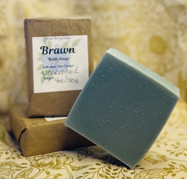 Three bars of Brawn soap stacked with one unwrapped and standing on its corner.