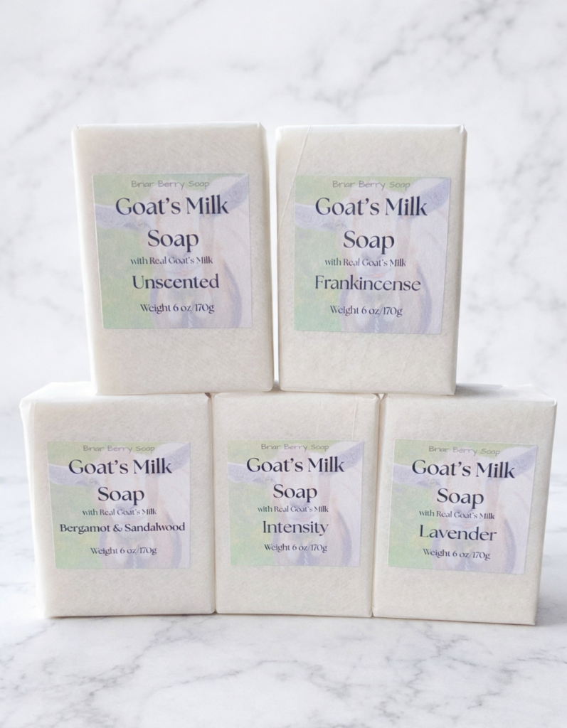 Five bars of Goat’s Milk Soap by Briar Berry Soap in Unscented, Frankincense, Bergamot & Sandalwood, Intensity, and Lavender on white marble