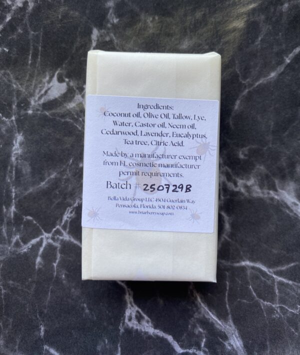 The back of one bar of Dont Bug Me on black and white marble background